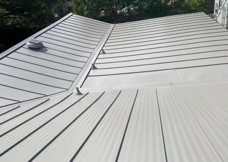 Solar attic fan installed on a metal roof for Roof Ventilation in Coweta